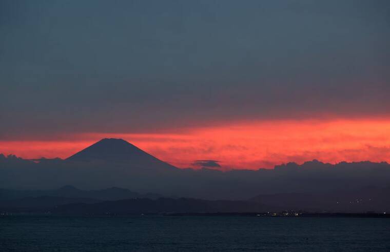 REUTERS/Molly Darlington / 2021 Mount Fuji is seen from Enoshima Island, in Fujisawa, south of Tokyo, Japan.